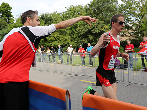 Marcel Berni erhält von Verpfleger Johnny Morgenthaler im EM-Halbmarathon in Amsterdam eine Flasche gereicht